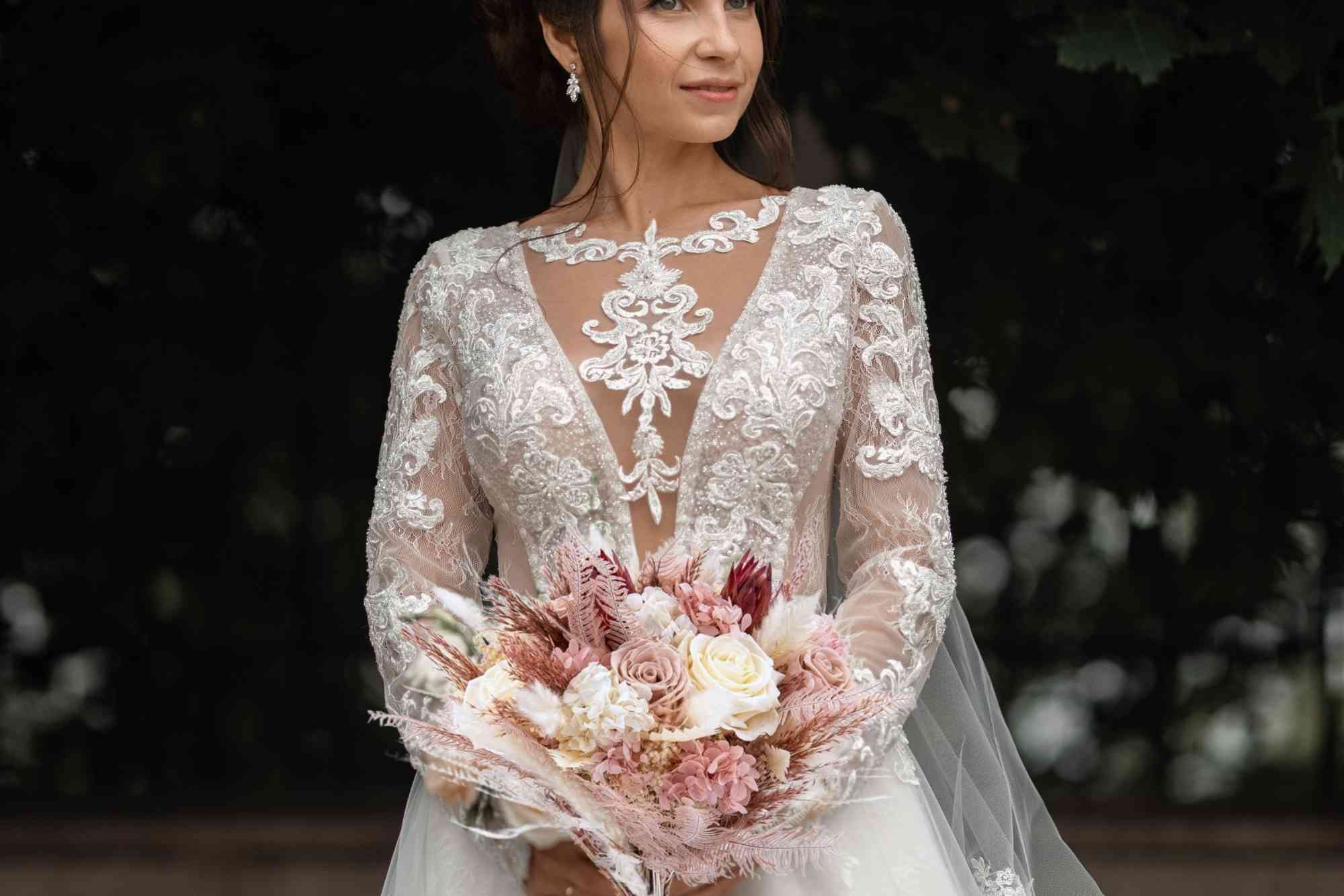 a bride is holding the preserved flower bouquet